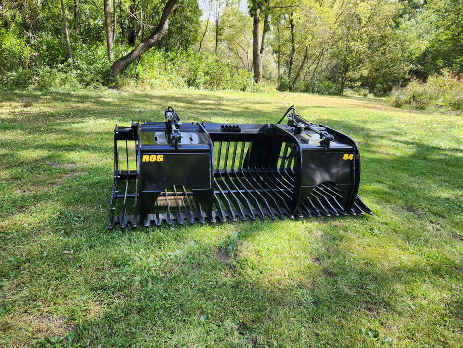 Close-up of Stinger open-side skid steer grapple bucket tines and hydraulic arms – engineered for strength, precision, and control."