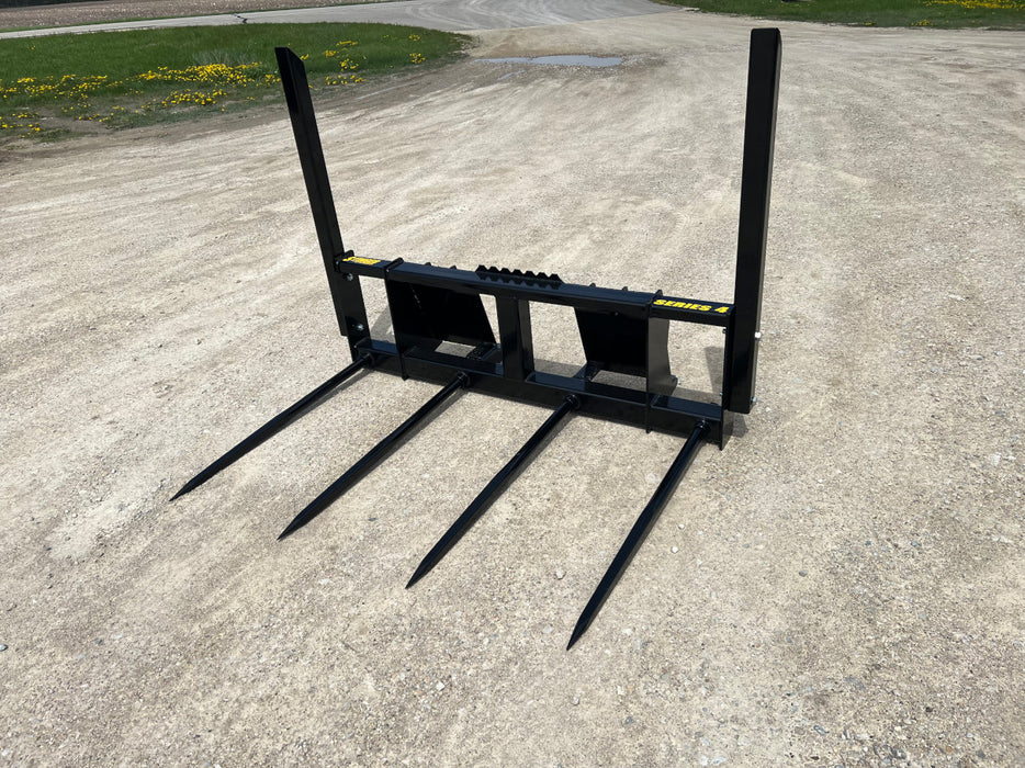 Stinger Series 4 bale spear mounted on tractor lifting dense square hay bales – precision-engineered attachment for efficient bale transport.
