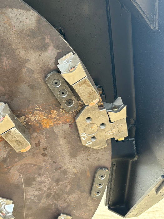 Side profile of Stinger skid steer disc mulcher operating in thick brush – compact yet powerful design for efficient land clearing.