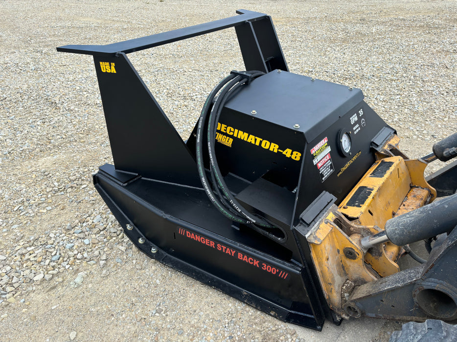 Stinger skid steer disc mulcher mounted on loader cutting through saplings – high-performance attachment for forestry and land reclamation.
