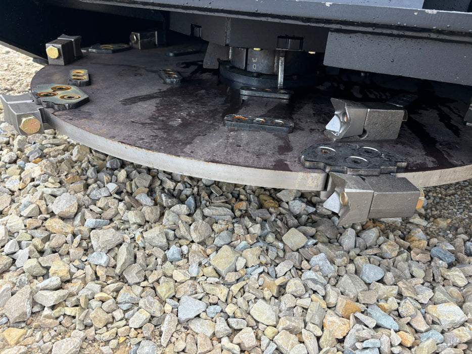 Stinger Decimator skid steer disc mulcher processing fallen trees and shrubs – durable attachment for large-scale brush management.