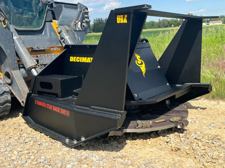 Stinger Decimator disc mulcher attached to skid steer clearing roadside vegetation – dependable forestry tool for commercial use.