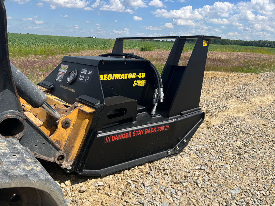 Durable skid steer disc mulcher by Stinger tackling thick brush and wood debris – designed for rugged terrain and heavy workloads.
