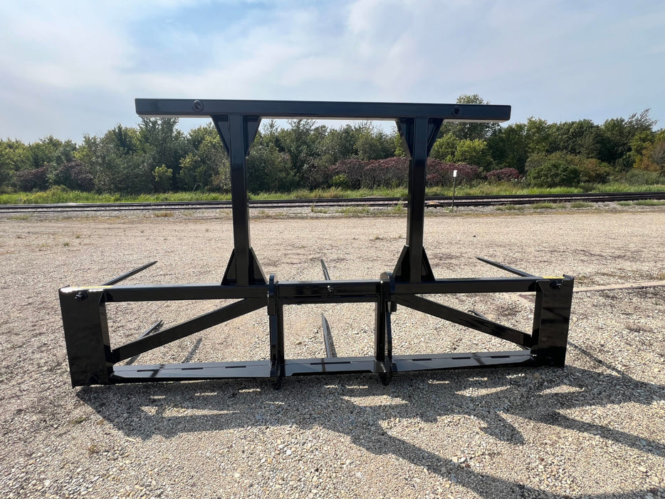 Stinger 5XD skid steer bale spear carrying several round bales – reinforced frame provides superior strength and stability.