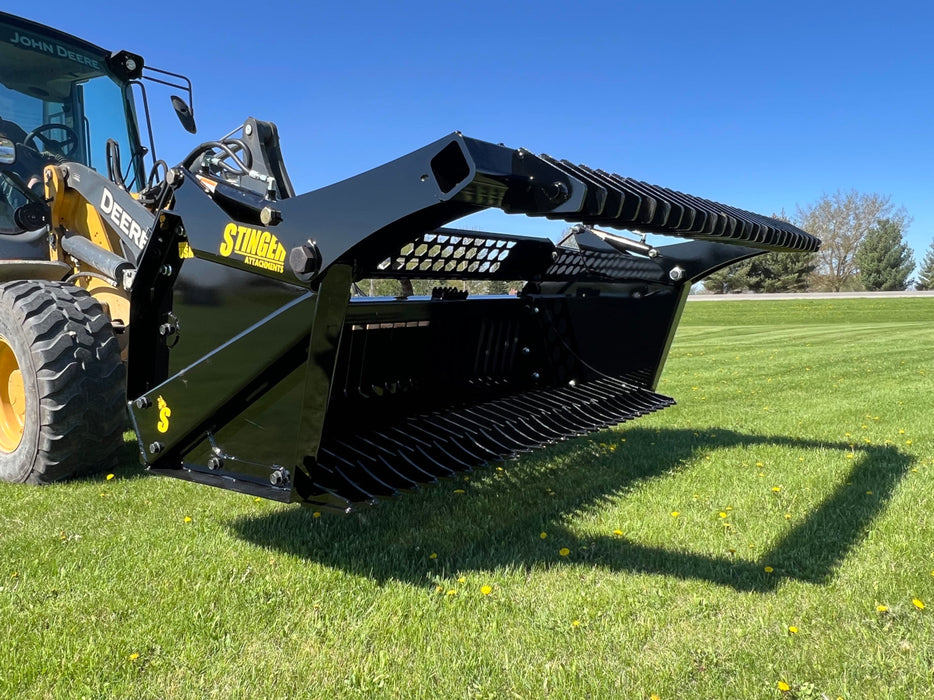 Close-up of the tractor rock bucket tines showing reinforced steel construction for durability and precision sorting.