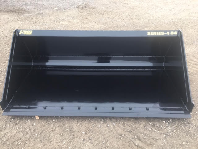 Operator using Stinger Series 4 skid steer material bucket to load gravel – robust construction ideal for landscaping, construction, and farming.