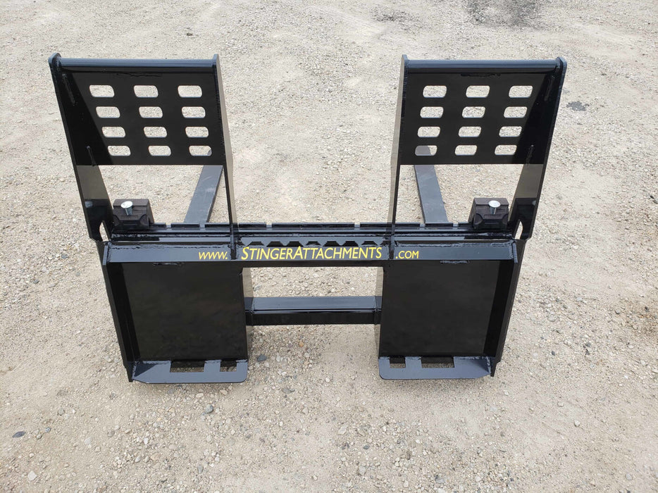 Stinger skid steer pallet forks moving construction materials – strong and precise attachment designed for professional jobsite use.