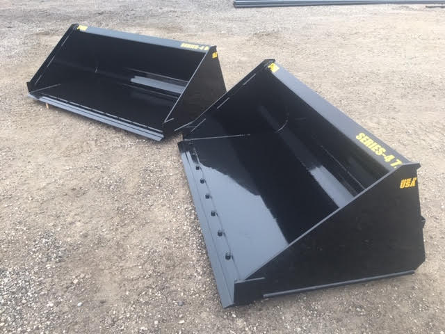 Front view of Stinger heavy-duty skid steer material bucket dumping debris – powerful Series 4 attachment designed for strength and precision.