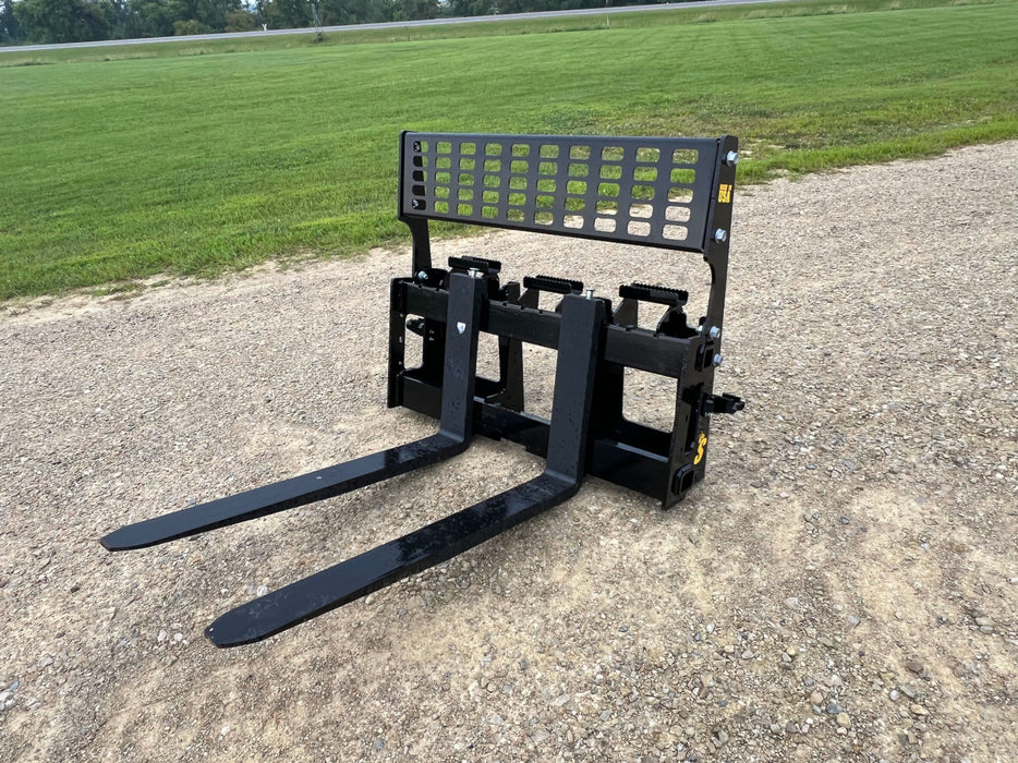 Side view of heavy-duty skid steer pallet forks by Stinger mounted on loader – designed for reliable performance on tough job sites.