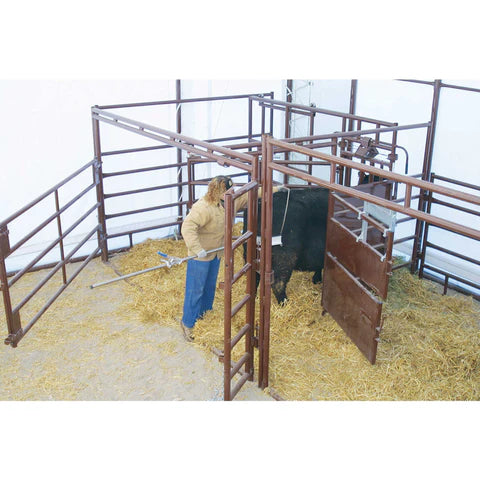 Rancher assisting a cow in the HiQual Classic Calving Pen designed for comfort, safety, and stress-free birthing.