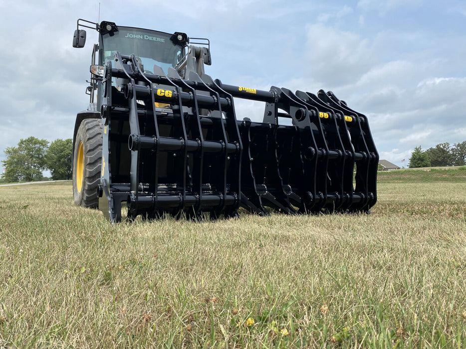 Industrial-grade tractor grapple bucket CG-XD resting on gravel, showing robust construction and precision welding.