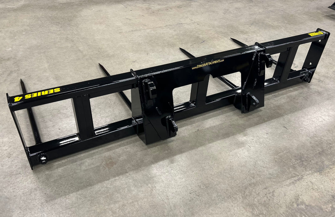 Farmer using Stinger double bale spear to move hay bales across pasture – dependable tool for fast, efficient bale handling.