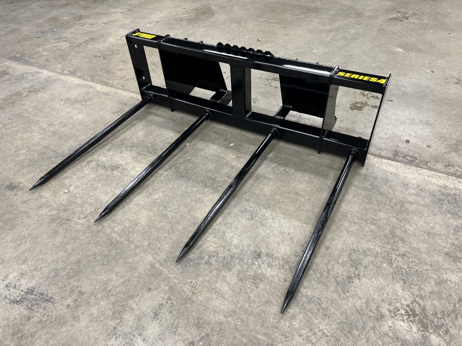 Stinger Series 4 bale spear moving large bales across open field – rugged attachment designed for long-lasting reliability in harsh farm conditions.