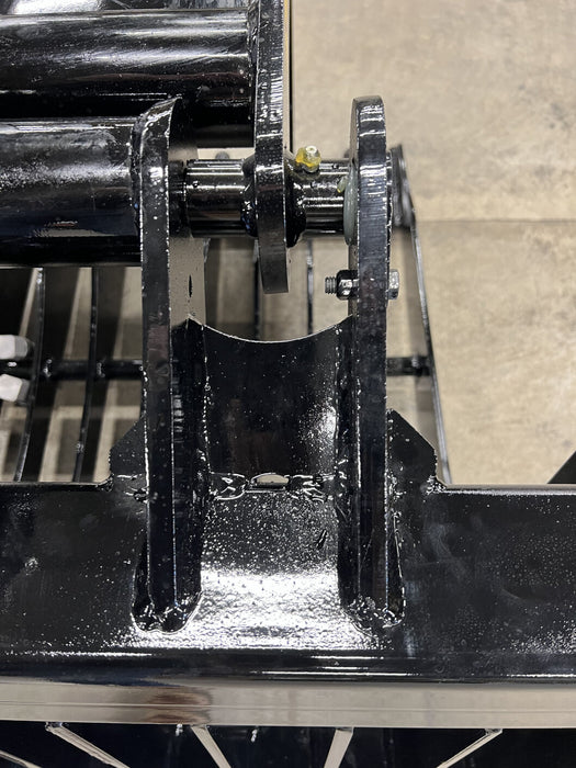 Heavy-duty skid steer rock bucket moving mixed soil and gravel – reliable skeleton design ensures effective separation and easy cleanup.