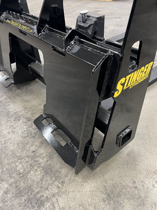Durable Stinger skid steer pallet forks supporting large load – reinforced steel build ensures maximum safety and stability.