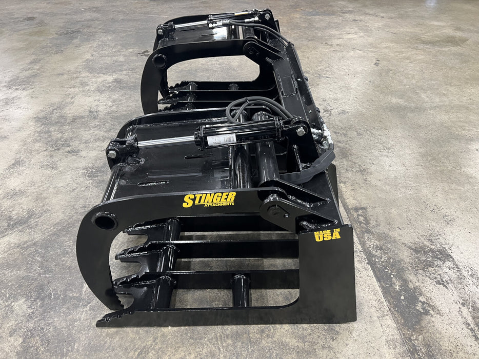 Close-up of the tractor root grapple tines showing reinforced steel design for powerful grip and durability.