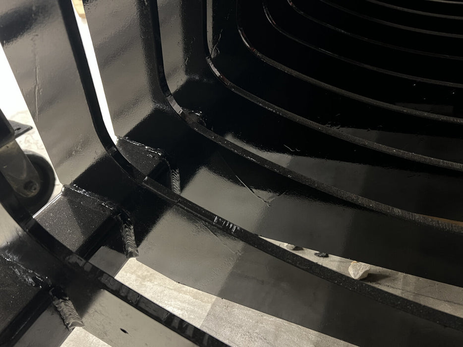 Front view of heavy-duty skid steer rock bucket filled with rocks – skeleton structure ensures precise sifting and reliable performance.