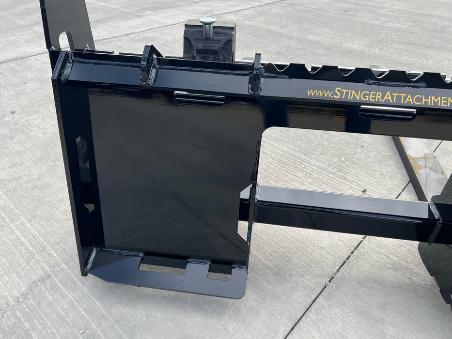 Stinger skid steer pallet forks handling construction supplies – professional-grade Class 2 attachment designed for daily heavy use.