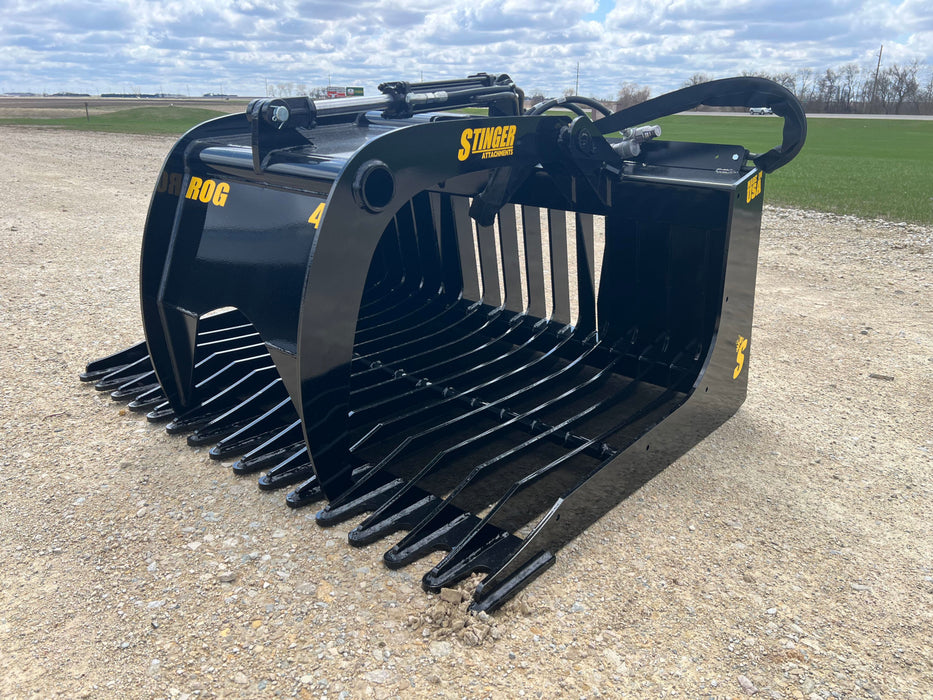 Heavy-duty skid steer grapple bucket gripping large stones – rugged 48-inch model built for strength, precision, and long-term performance.