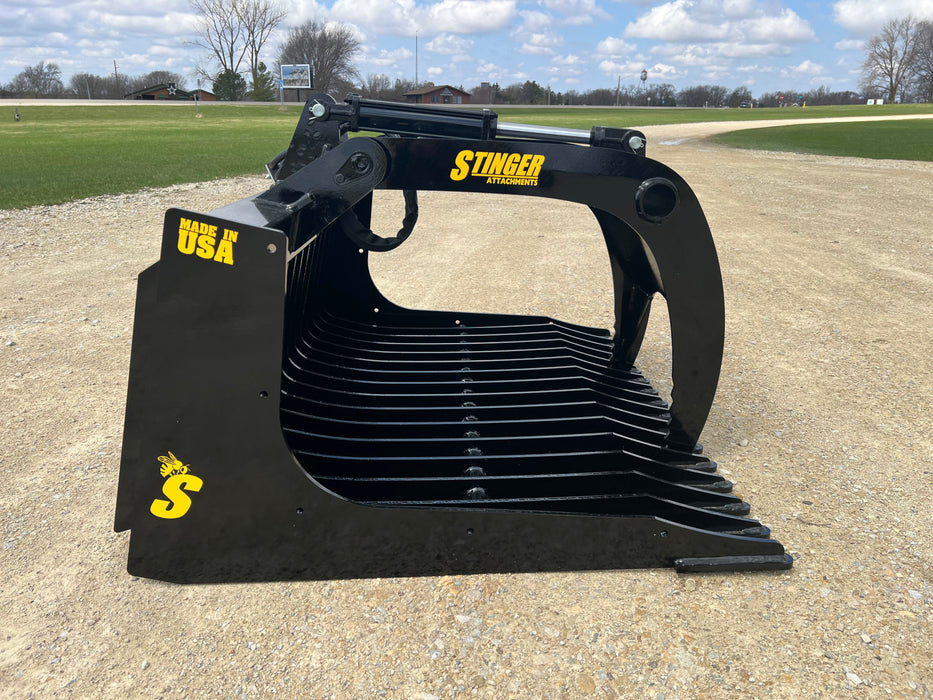 Close-up of 48-inch skid steer grapple bucket tines and hydraulic arms – engineered for durability and reliable gripping power.