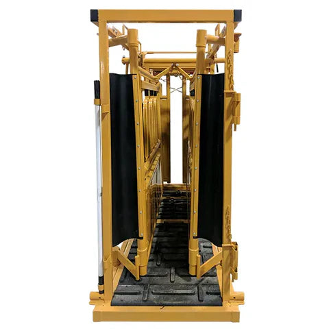 Side view of heavy-duty Sioux Steel Squeeze Cattle Chute showing manual operation and solid steel construction.