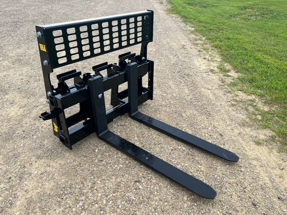 Front view of Stinger skid steer pallet forks lifting heavy materials – heavy-duty Class 3 model built for demanding lifting operations.