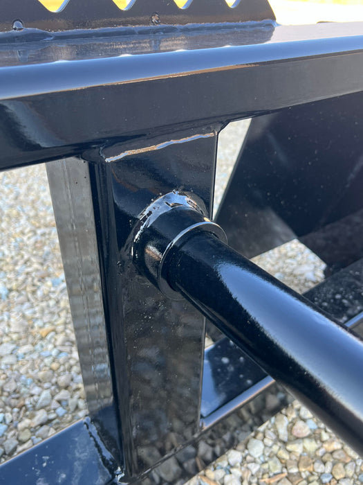 Stinger Series 1 bale spear moving hay bales across pasture – durable and efficient attachment designed for farmers and ranchers.