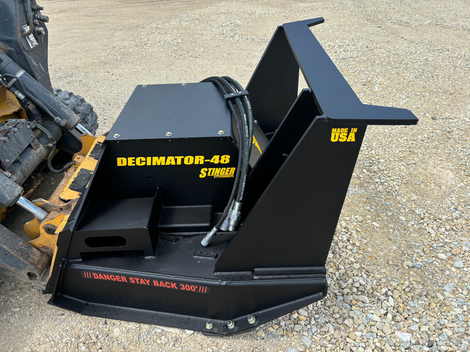 Heavy-duty Stinger Decimator skid steer disc mulcher cutting dense brush – durable attachment designed for professional land clearing work.
