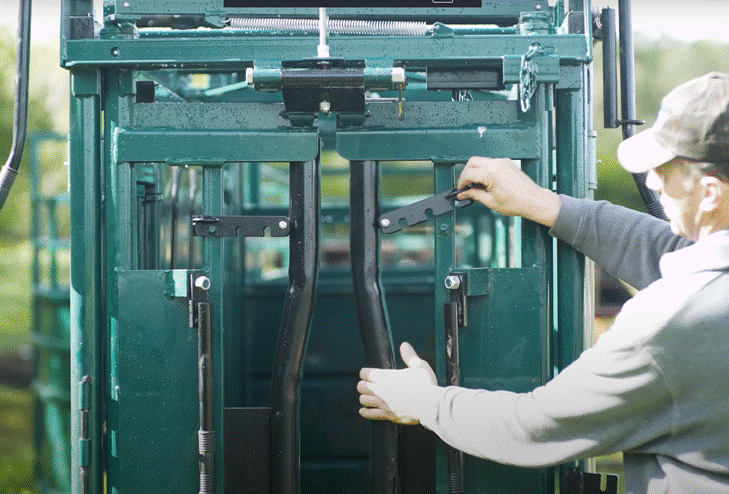 Side view of Lakeland E-Series cattle squeeze chute showing sturdy steel construction and easy-access side panels
