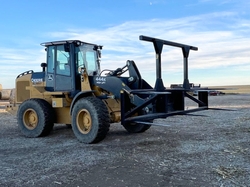 Industrial-grade Bale Spear 5XD resting on gravel, highlighting its reinforced steel frame and design.