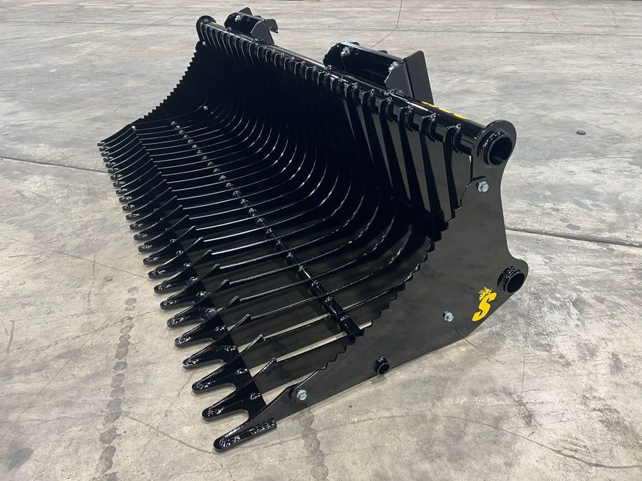 Stinger compact rock bucket clearing rocky terrain – heavy-duty attachment ideal for property maintenance and excavation projects.