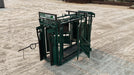 Farmer operating the E-Series Cattle Squeeze Chute for efficient and stress-free cattle handling