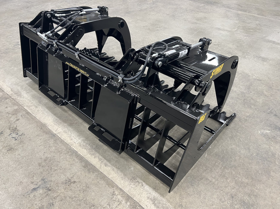 Industrial-grade Rock Grapple resting on gravel, highlighting durable tines and welded structural frame.