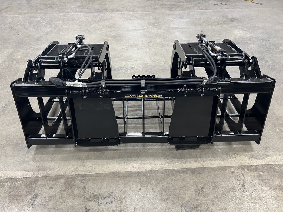 Tractor-mounted Rock Grapple lifting rocks and logs, showcasing versatility for farm and construction use.