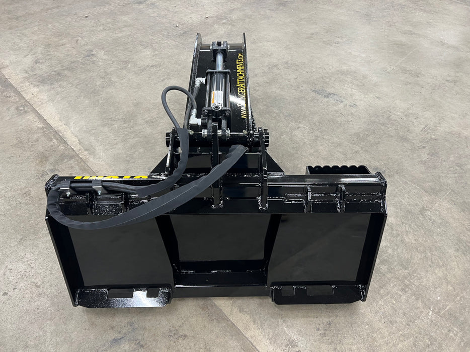 Tractor loader with a Stump Grapple Bucket attachment transporting debris across a cleared lot.