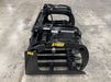 Rear angle of the tractor root grapple mounted on a front loader, showcasing easy quick-attach connection.