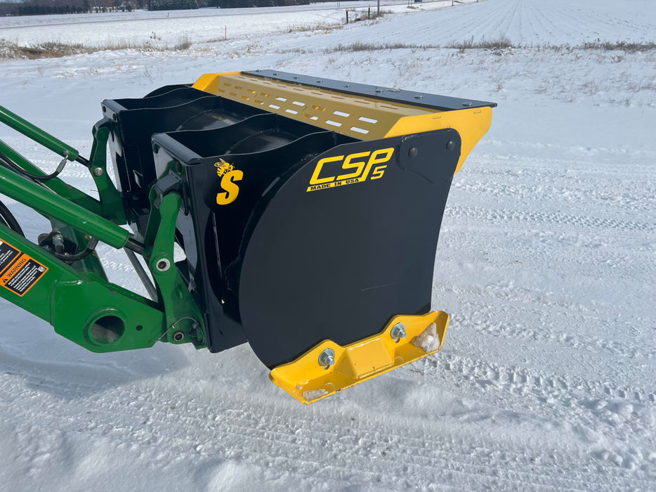 Front view of compact skid steer snow pusher in action – reinforced steel blade ensures durability and precision in snow removal.