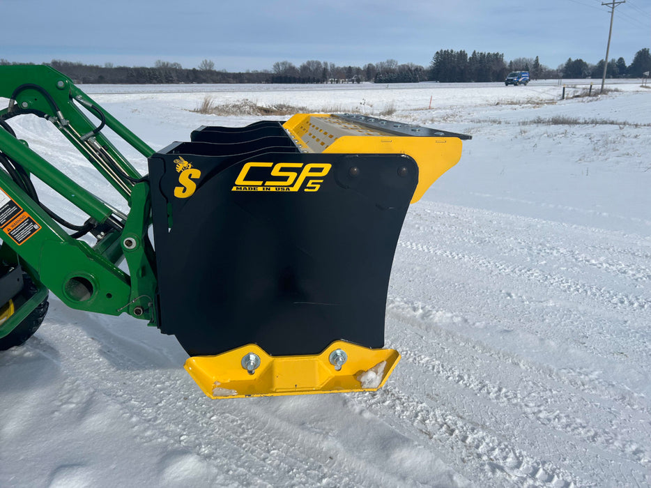 Compact skid steer snow pusher attachment moving snow along pavement – heavy-duty construction built for long-lasting performance.