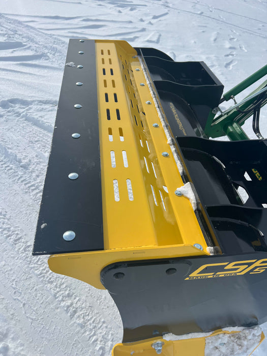 Close-up of compact skid steer snow pusher attachment – rugged build ensures dependable performance during harsh winter conditions.