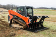Loflin Fabrication skid steer root grapple handling logs and brush – standard duty attachment designed for efficient land clearing and debris removal.