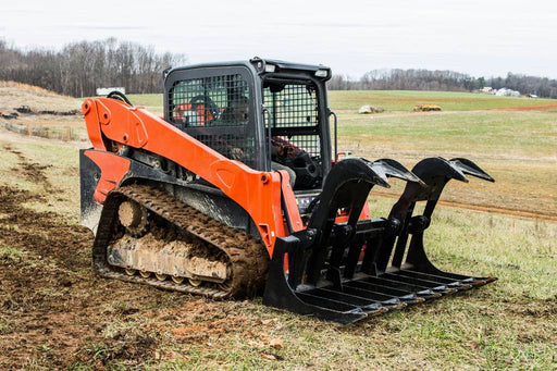 Loflin Fabrication skid steer root grapple handling logs and brush – standard duty attachment designed for efficient land clearing and debris removal.