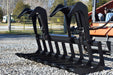 Loflin heavy-duty Root Grapple attachment for skid steer, designed for efficient handling of roots, brush, and debris during land clearing.