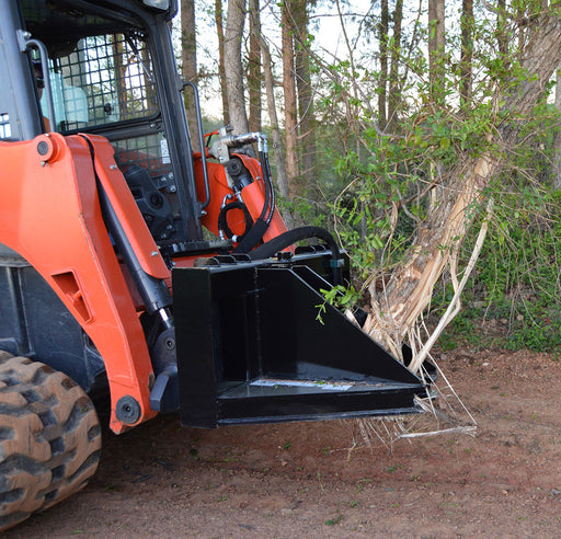 Loflin Fabrication skid steer tree puller gripping and removing small trees and brush – heavy-duty attachment built for land clearing and vegetation control.